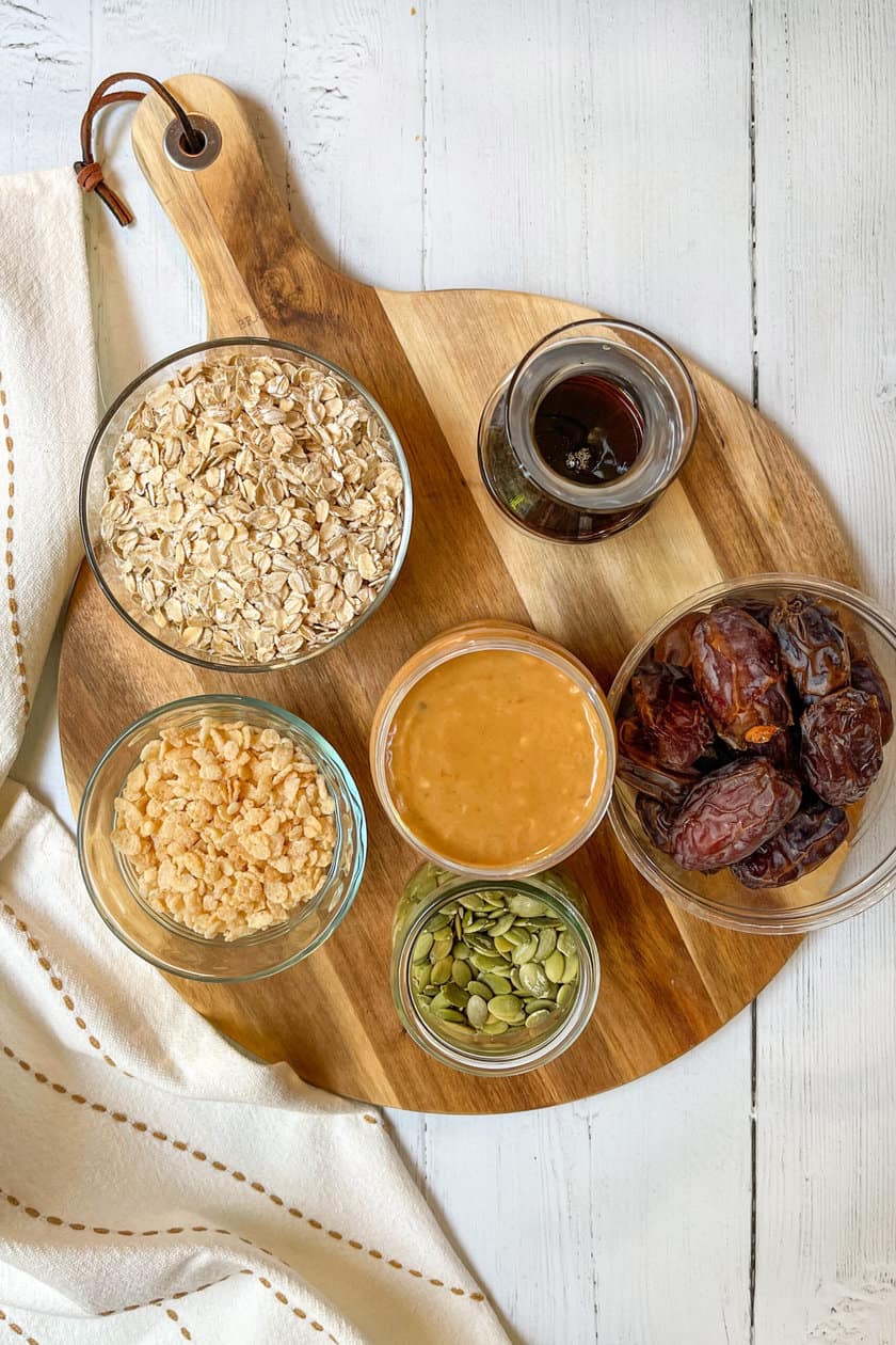 Top view of ingredients for Chewy Granola Bars on a round wood board