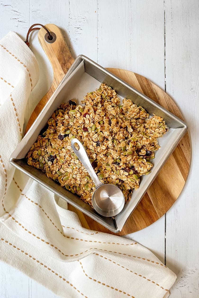 Top view of granola bars pressed into square baking pan