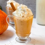 Creamy homemade pumpkin spice latte topped with whipped cream and warm pumpkin pie spice.