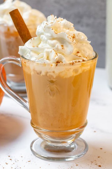 Creamy homemade pumpkin spice latte topped with whipped cream and warm pumpkin pie spice.