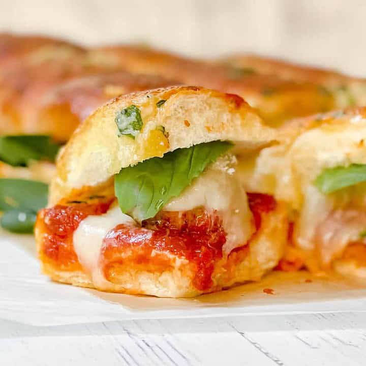 Closeup view of Meatball Hawaiian Roll Slider with basil, marinara and melting mozzarella cheese