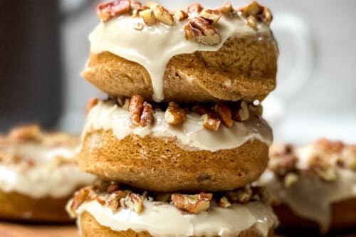 Stack of 3 Baked Maple Donuts on a wooden paddle