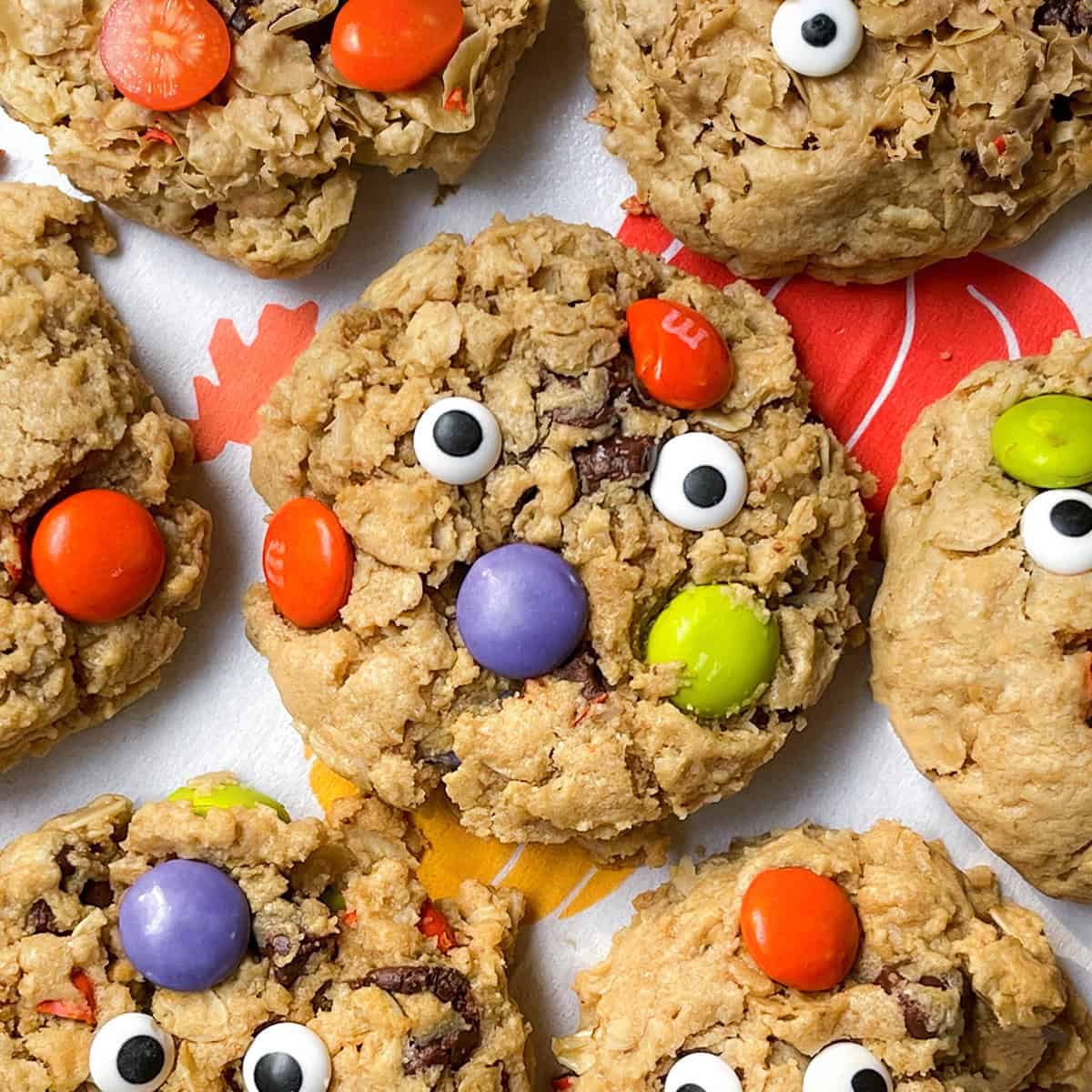 Closeup view of Monster chocolate chip oatmeal cookies with candy eyes.