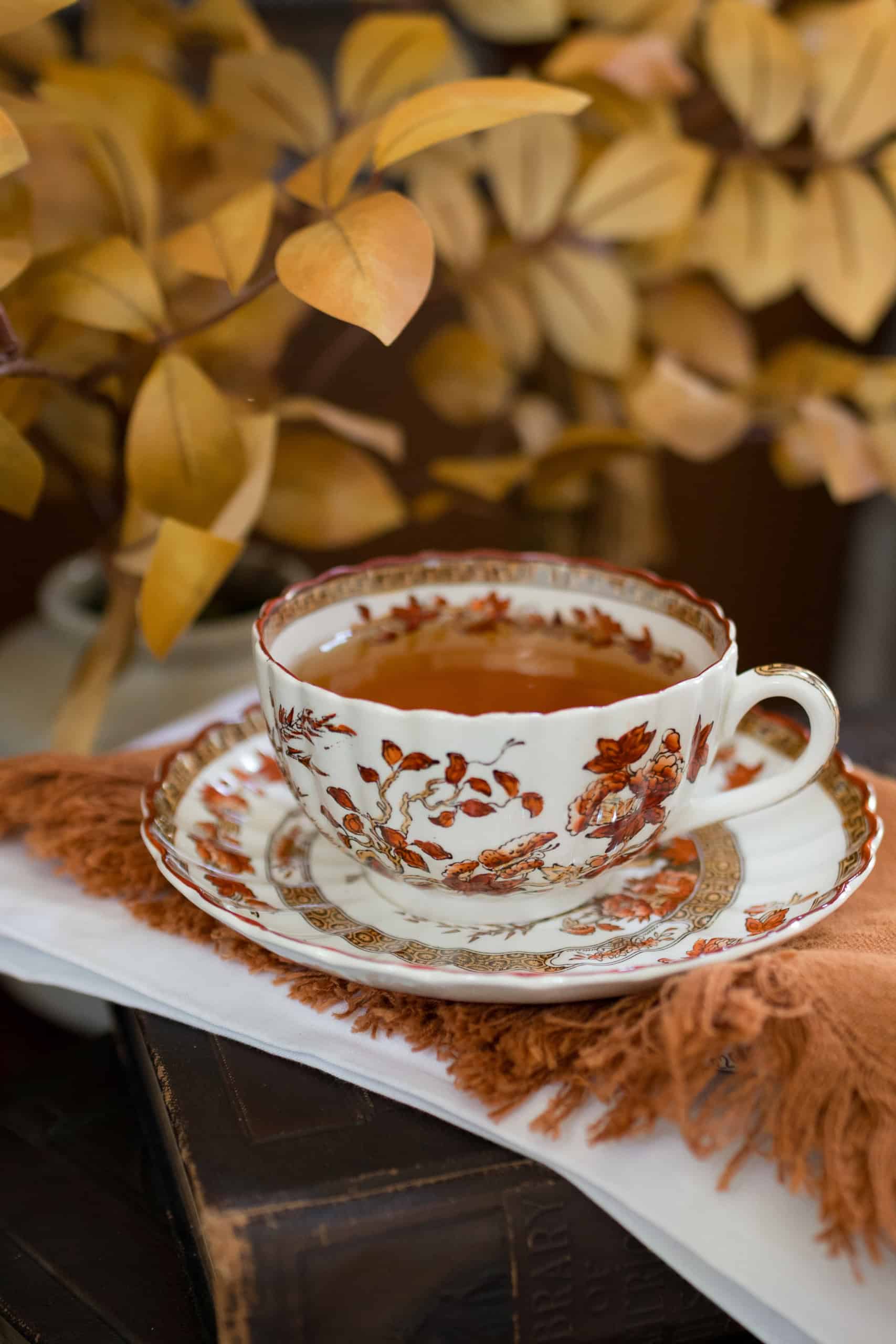 Spode India Tree teacup filled with black tea for an autumn Harvest tea table.