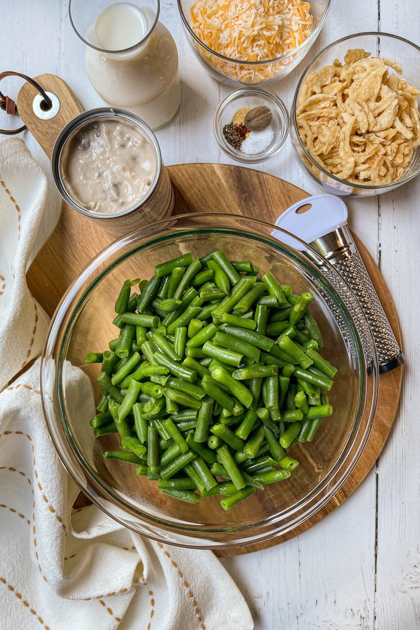 Top view of Green Bean Casserole ingredients on a round wood board