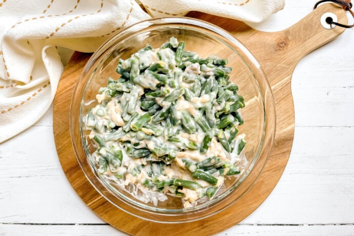 Top view of unbaked Green Bean Casserole filling in a glass bowl