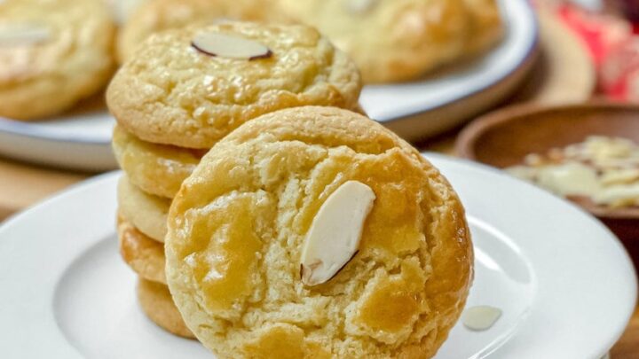 Side view of Chinese Almond Cookie leaning against a stack on a white plate.