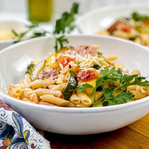 Sausage Pasta in white pasta bowl with fresh parsley