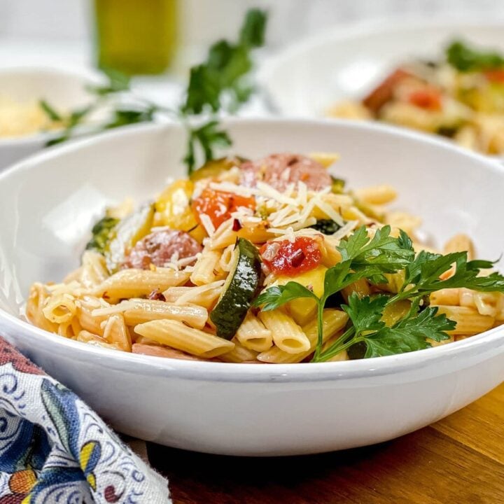 Sausage Pasta in white pasta bowl with fresh parsley
