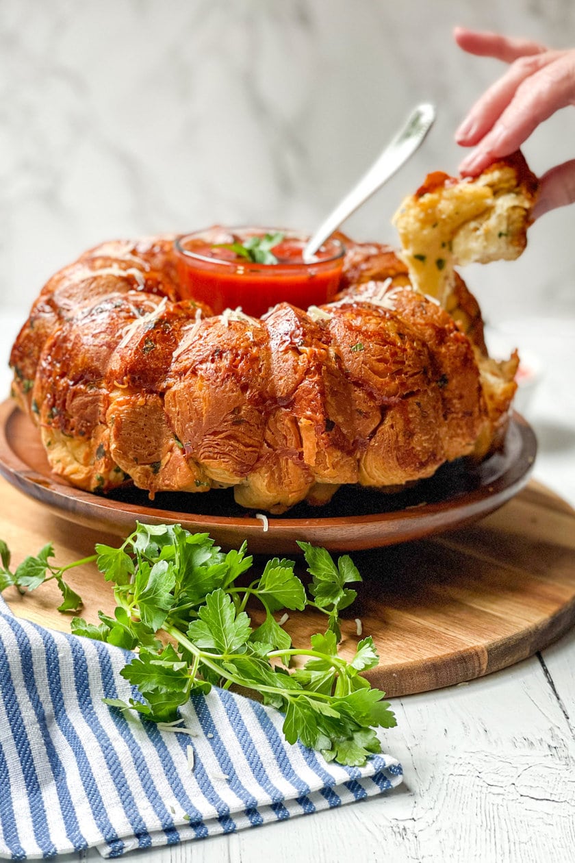 Side view of garlic bread being pull apart.