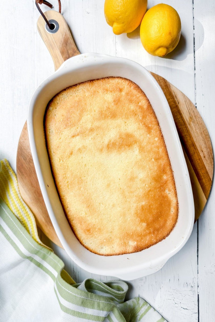 Top view of Baked Lemon Pudding on a round wood board