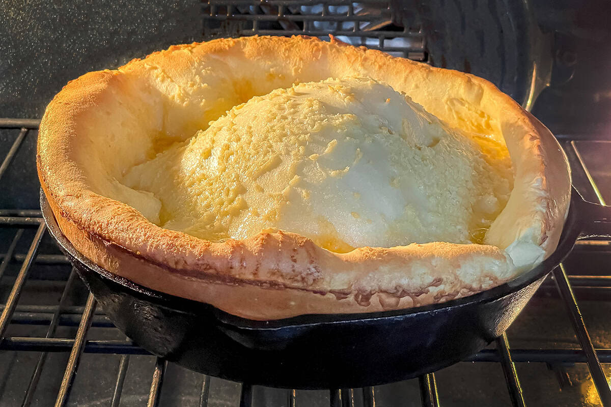 Dutch Baby German Pancake puffed and golden sitting in the oven.