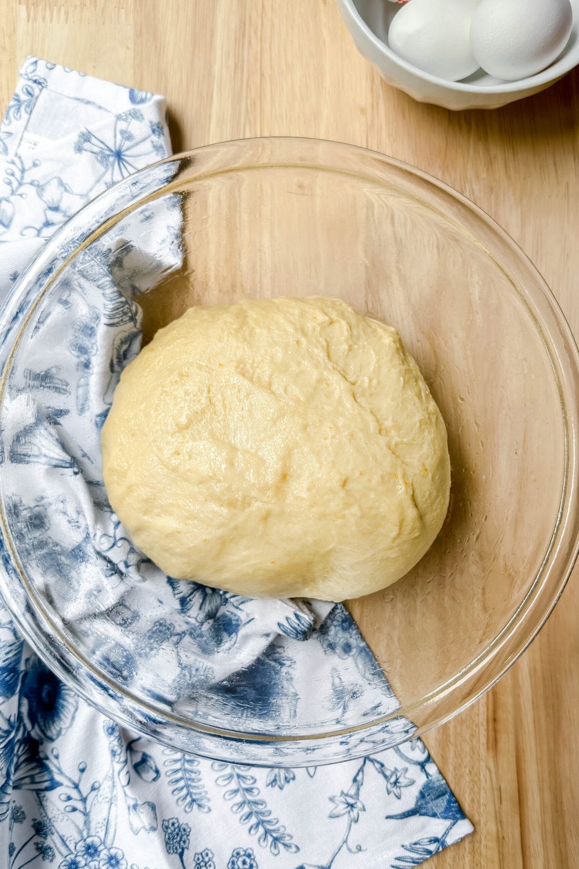 Top view of just kneaded Italian Easter Bread dough in an oiled glass bowl
