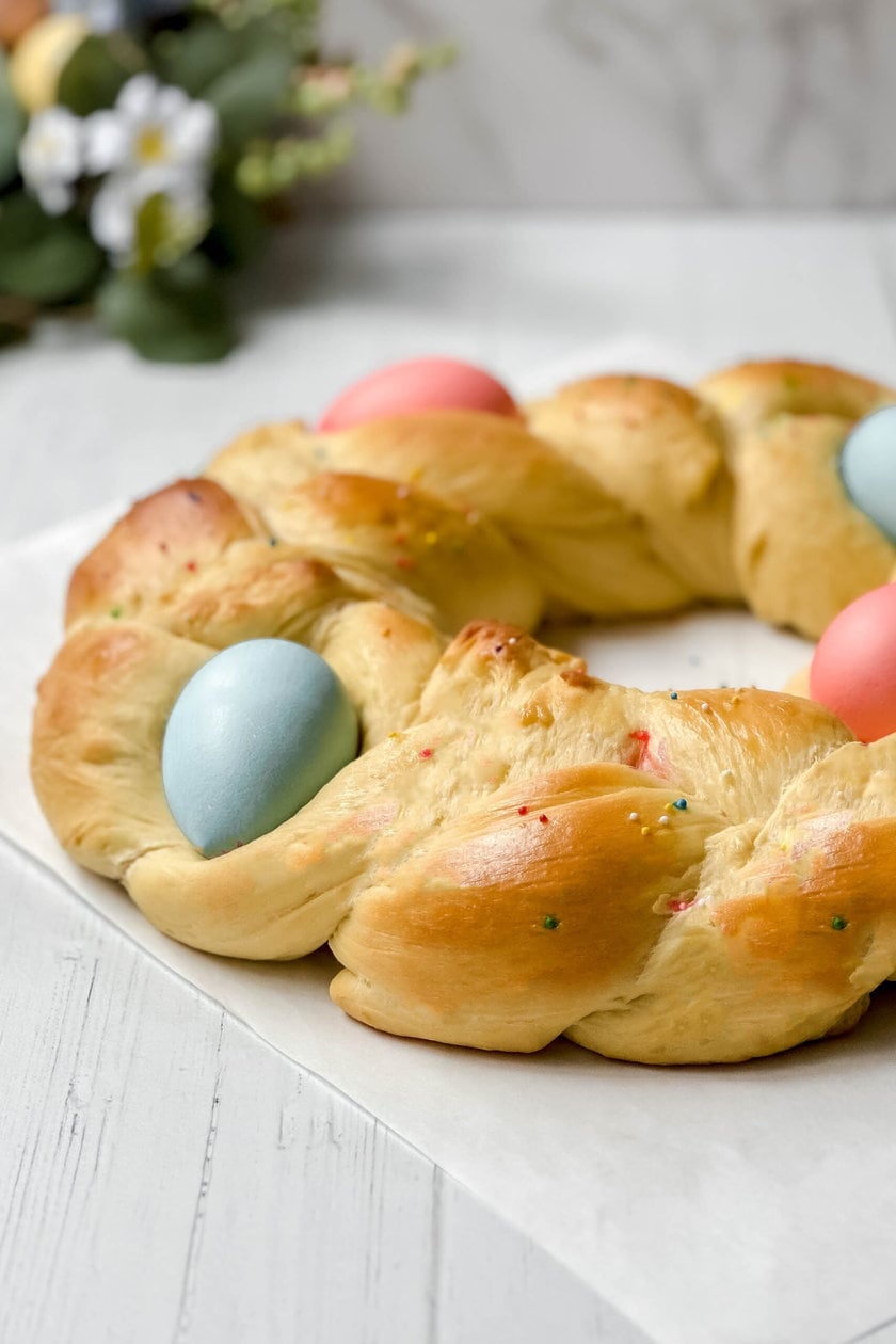 Side view of Italian Easter Bread with blue and pink dyed Easter eggs