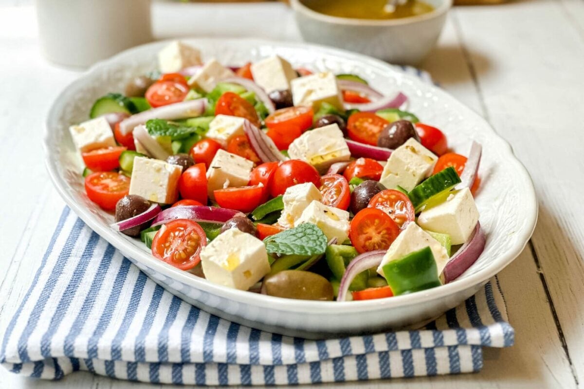 Side view of Greek Salad on a white oval serving platter