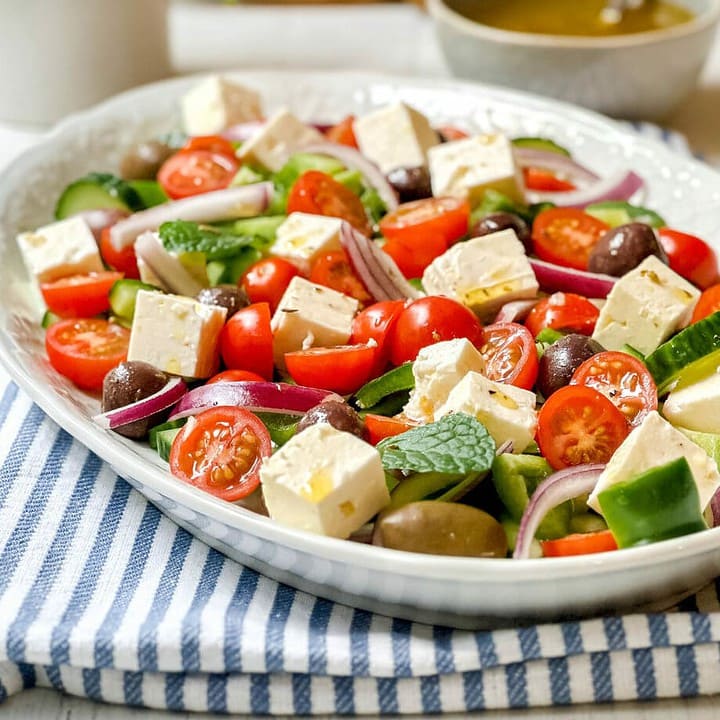 Side view of Greek Salad on a white oval serving platter