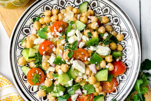Top vertical view of chickpea salad with fresh herbs, homemade lemon vinaigrette and feta