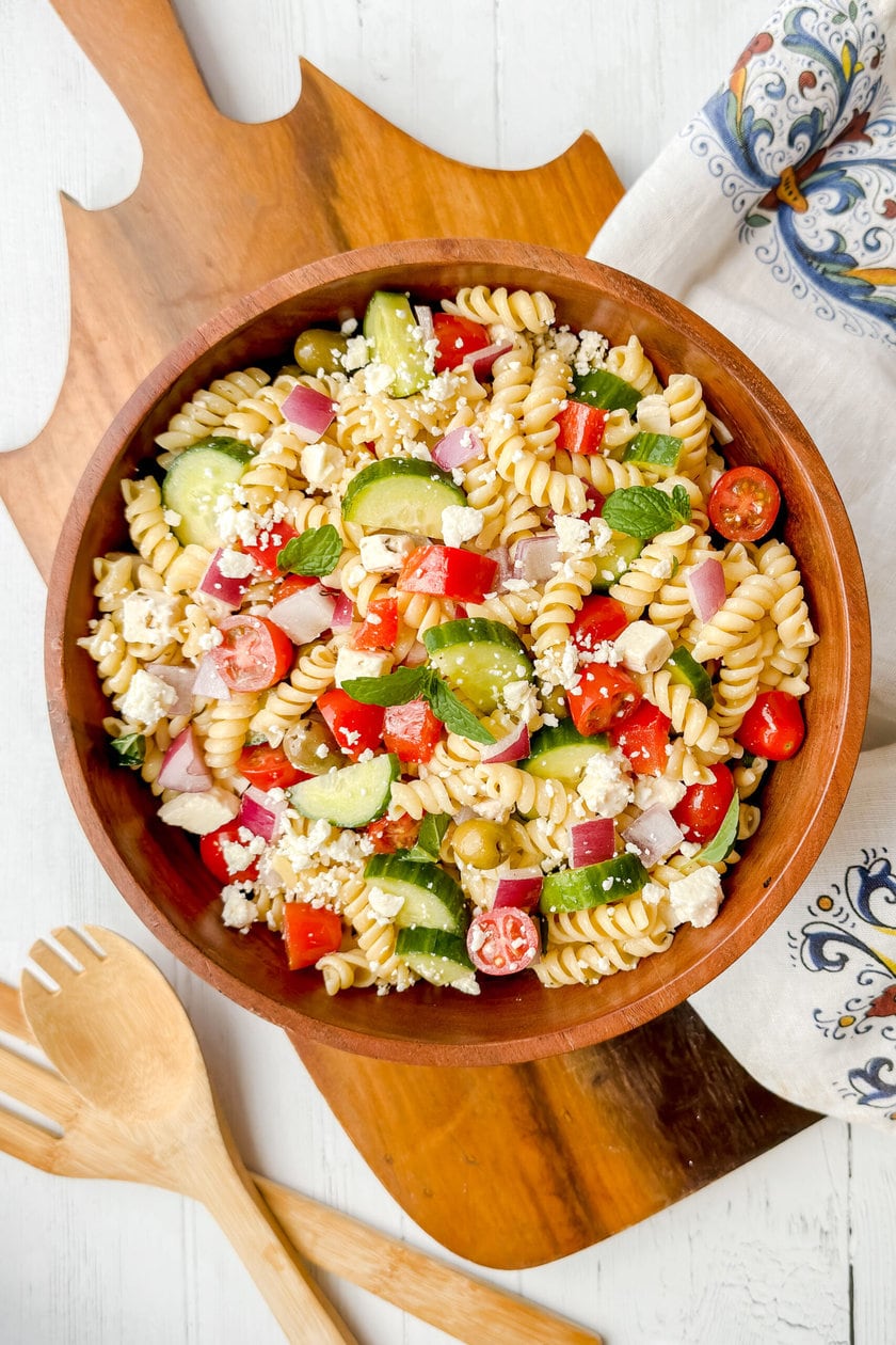 Top view of Greek Pasta Salad in a large wood serving bowl