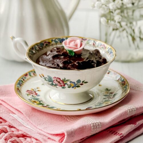Side view of Chocolate Pudding in a teacup with a pink edible rose