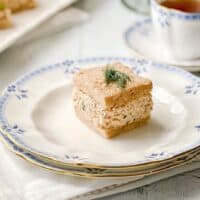 Closeup view of Salmon Salad Tea Sandwich on wheat bread with a sprig of dill