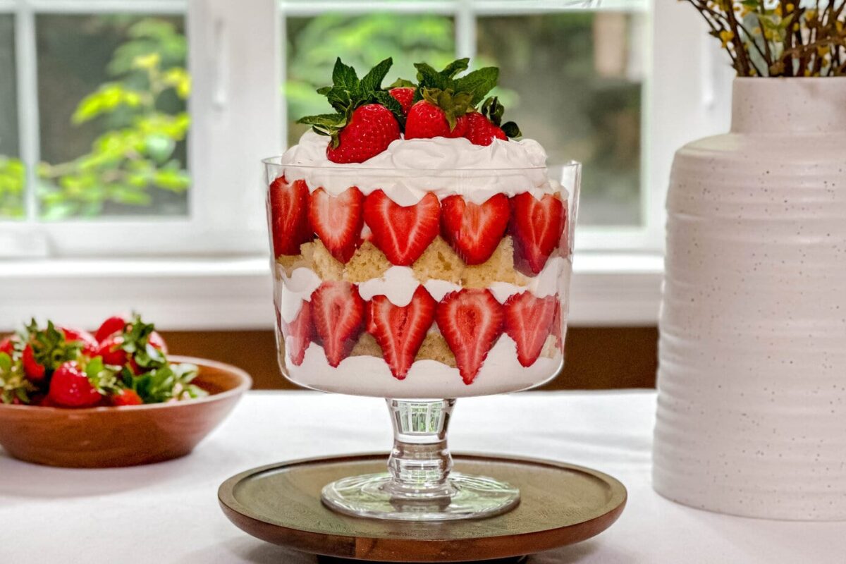 Side view of Strawberry Trifle on a table in front of a summer window