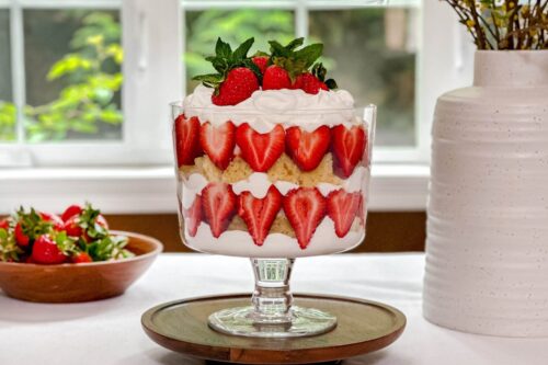 Side view of Strawberry Trifle on a table in front of a summer window