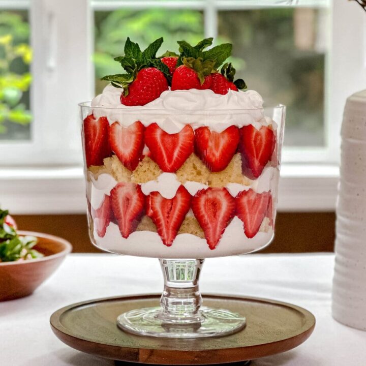 Side view of Strawberry Trifle on a table in front of a summer window