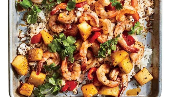 Top view of sheet pan Hawaiian shrimp recipe over rice on a silver sheet pan.