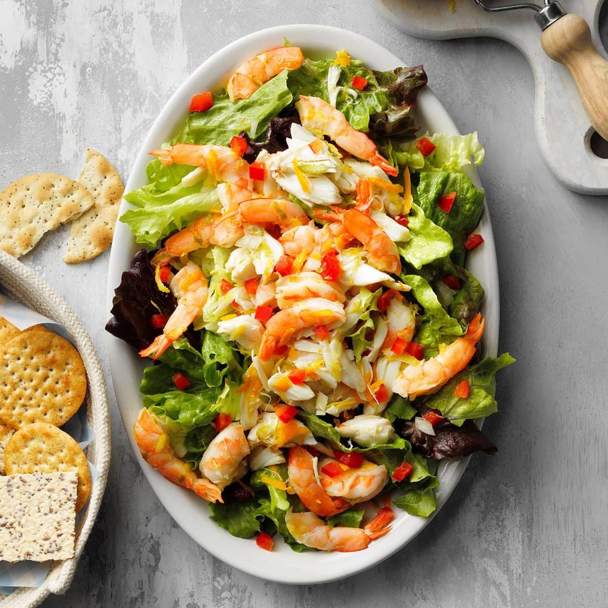 Top view of an easy Citrus Seafood Salad on a white oval serving platter.