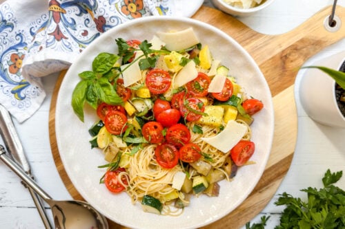 Top view of Garden Pasta with zucchini, squash, eggplant, cherry tomatoes and fresh herbs