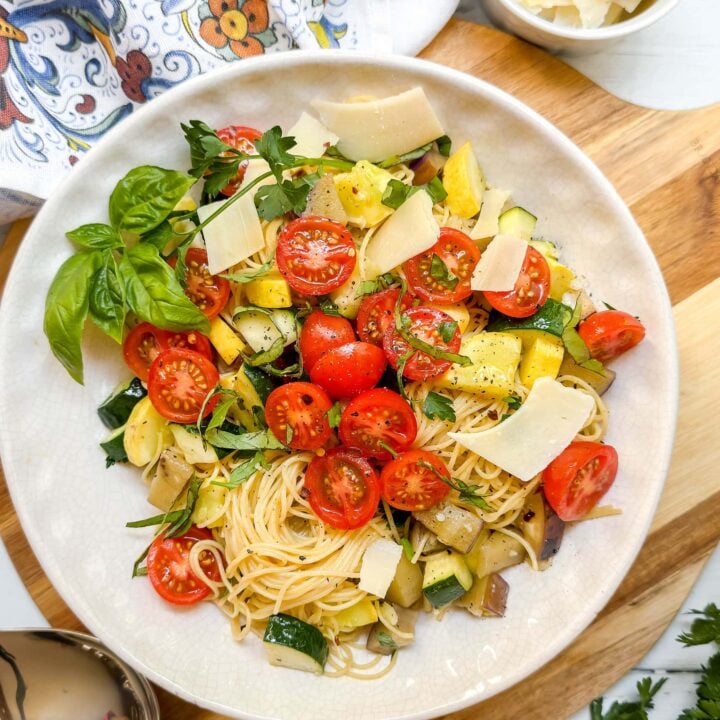 Top view of Garden Pasta with zucchini, squash, eggplant, cherry tomatoes and fresh herbs