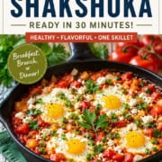 A skillet of shakshuka with poached eggs in tomato sauce, garnished with fresh herbs, sits on a table; text highlights this quick, healthy meal as a Mediterranean-inspired classic.