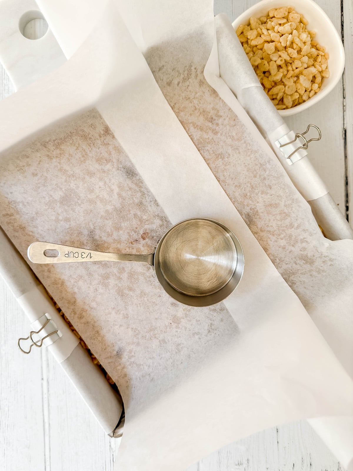 Pressing the Rice Bubble Slice mixture into a parchment-lined square pan