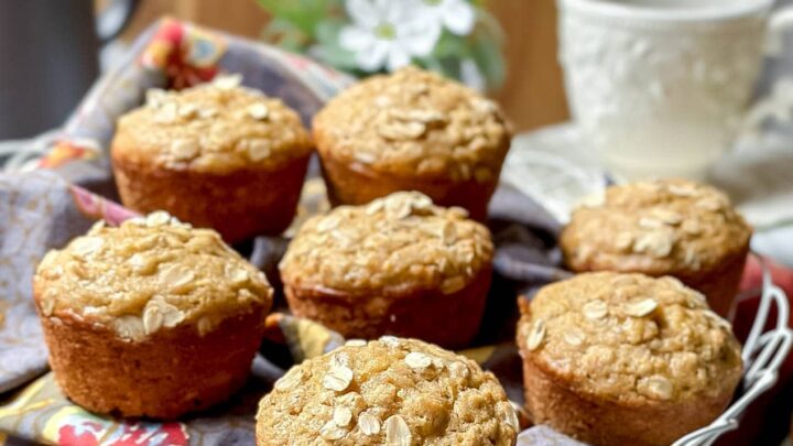 Side view of Apple Oatmeal Muffins in a white wire basket with tea