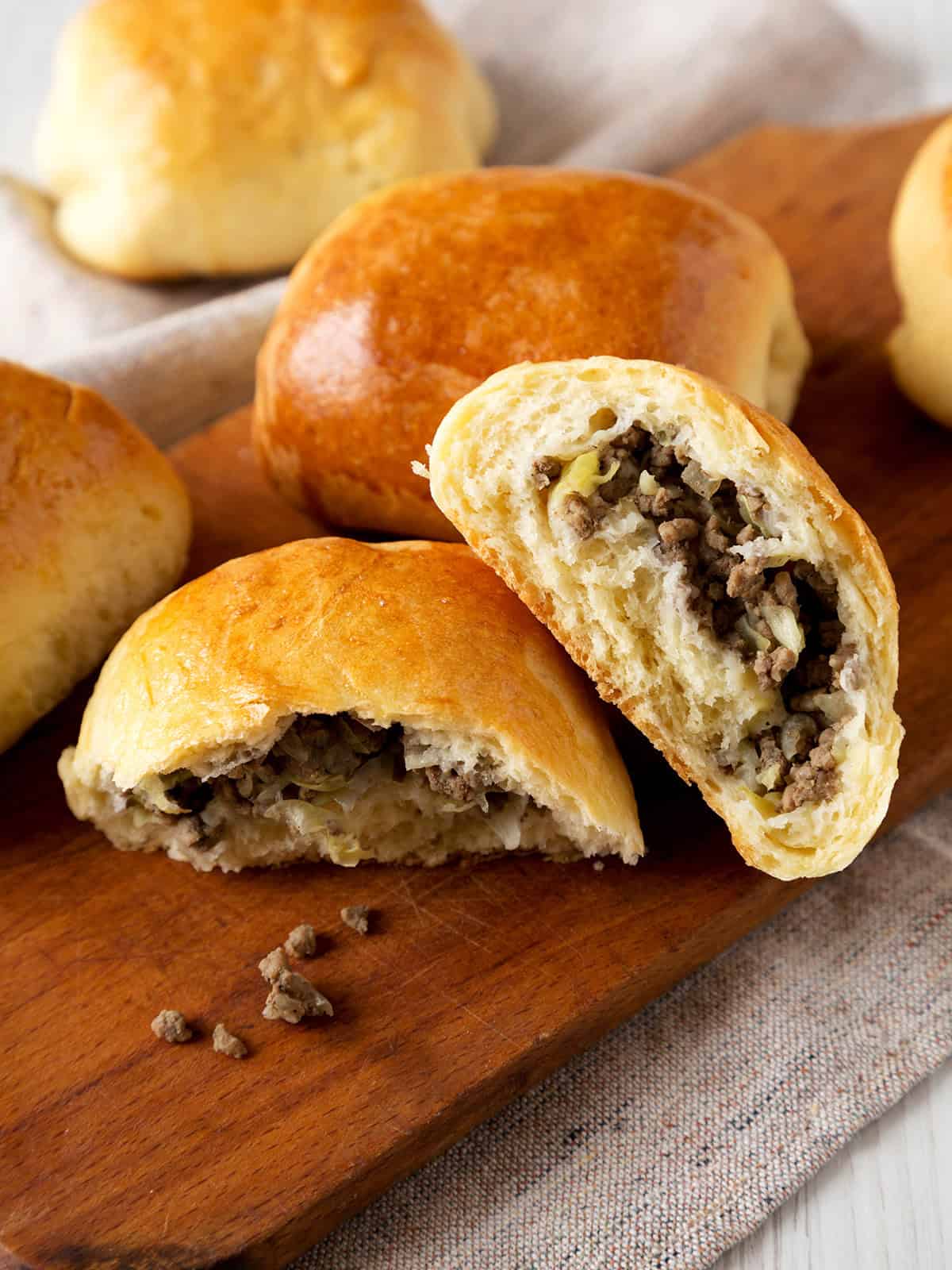 Closeup view of German bierocks on a wooden board for casual serving.