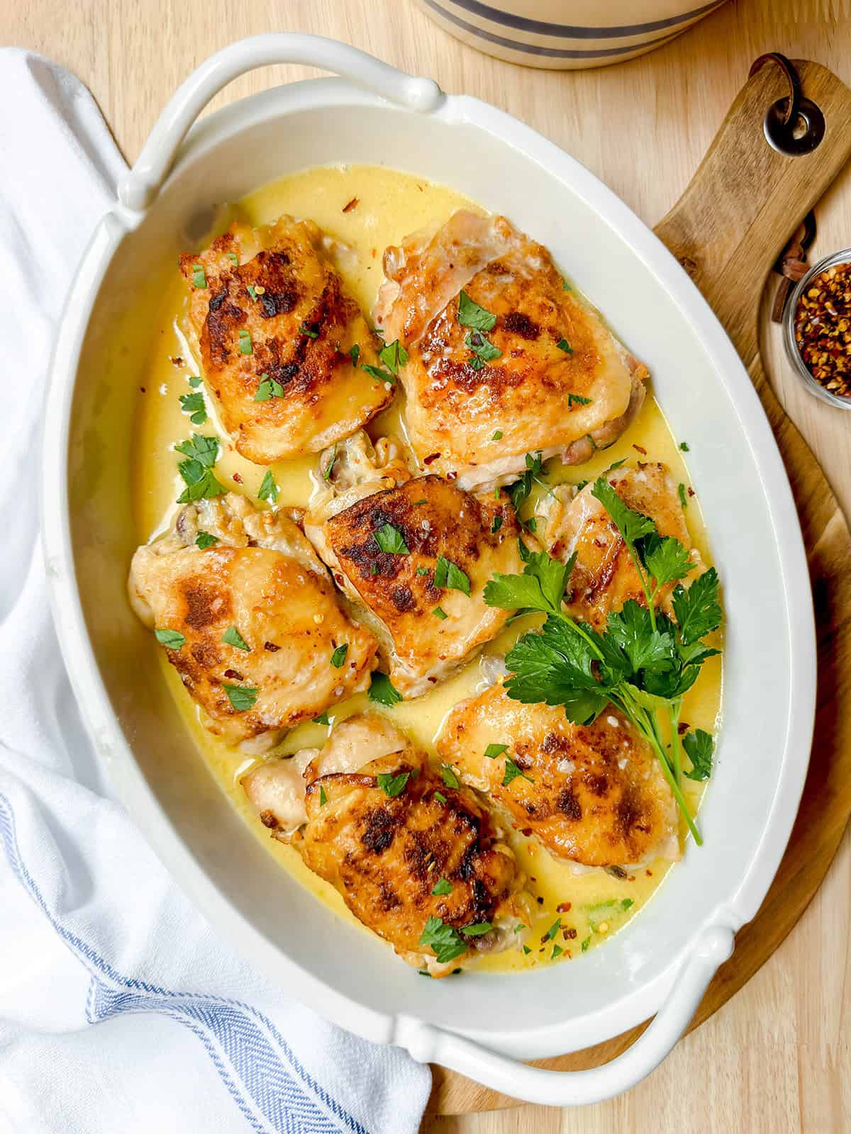 Slow Cooker chicken thighs in a creamy paprika sauce and garnished with fresh parsley.