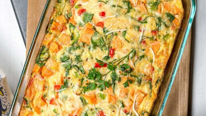 Top view of just baked Sweet Potato Casserole in a glass baking dish on a wooden board