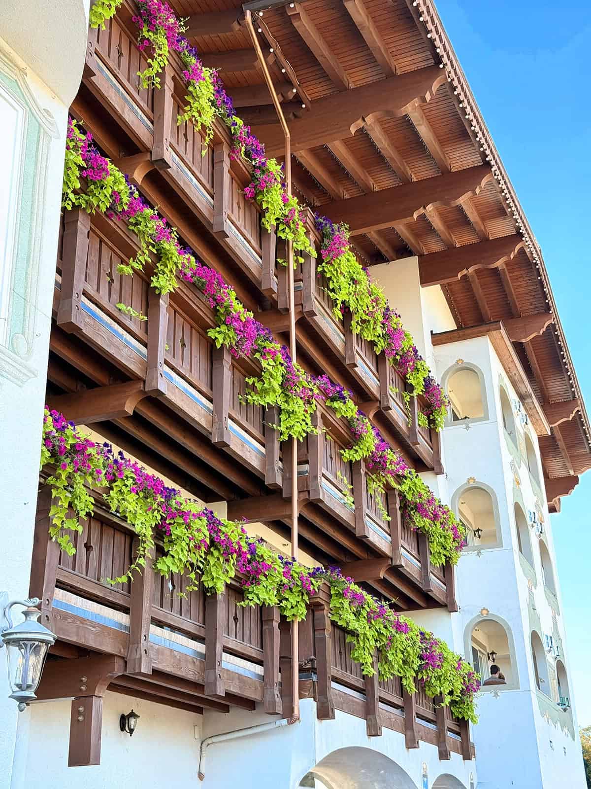 Wooden Bavarian-style balconies filled with colorful flowers in Leavenworth, Washington.