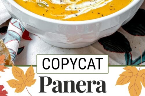 A bowl of creamy autumn squash soup, inspired by the Panera autumn squash soup recipe, garnished with pumpkin seeds, black pepper, and a swirl of cream. Presented on a patterned tablecloth with a text overlay: "Copycat Panera Autumn Squash Soup.