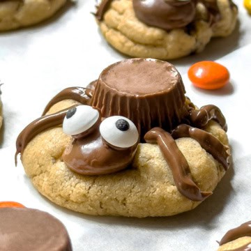 Closeup view of peanut butter chocolate spider cookies with candy eyes.