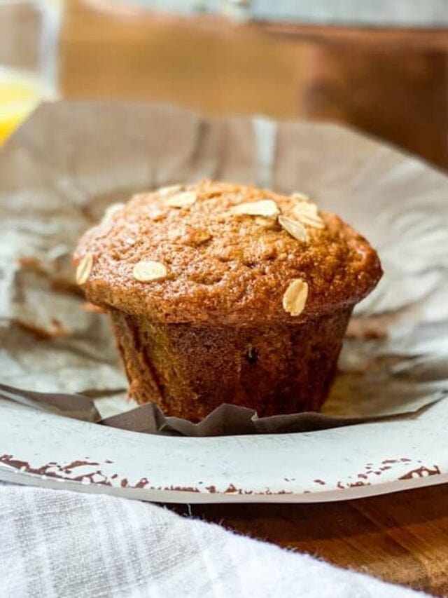 Unwrapped Morning Glory Muffin on a Plate with Orange Juice
