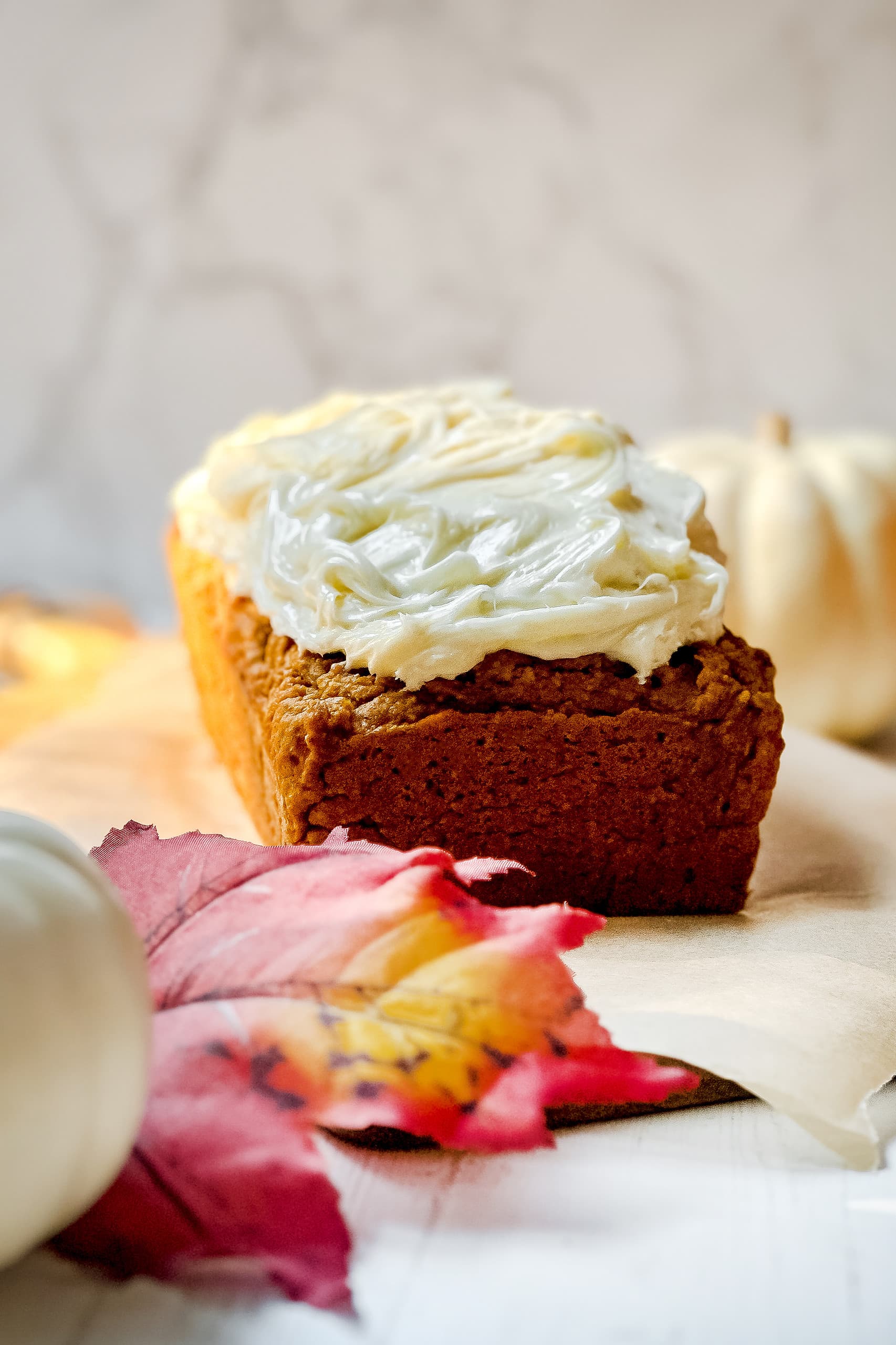 Closeup side view of cream cheese frosted pumpkin cracker bread