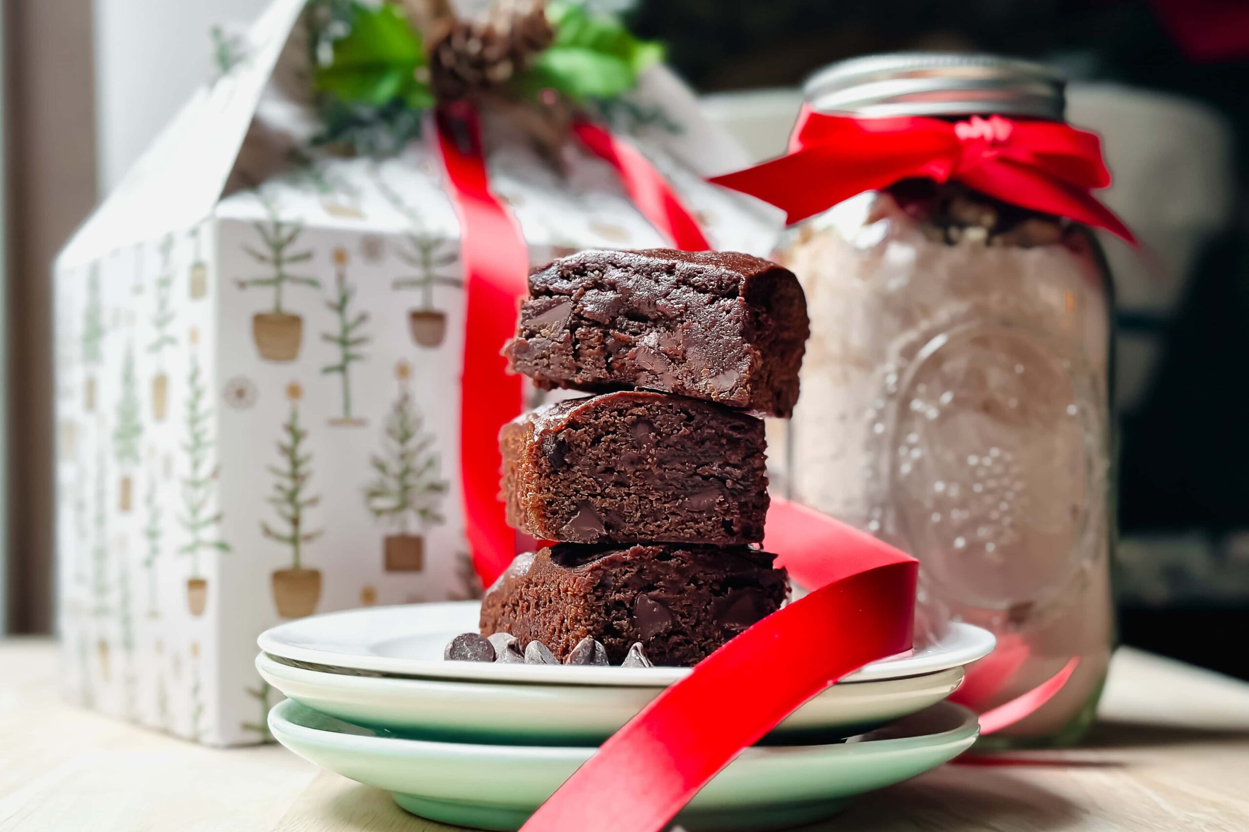 Horizontal view of stacked Brownie Mix brownies on a white plate for Mason Jar Food Gifts.