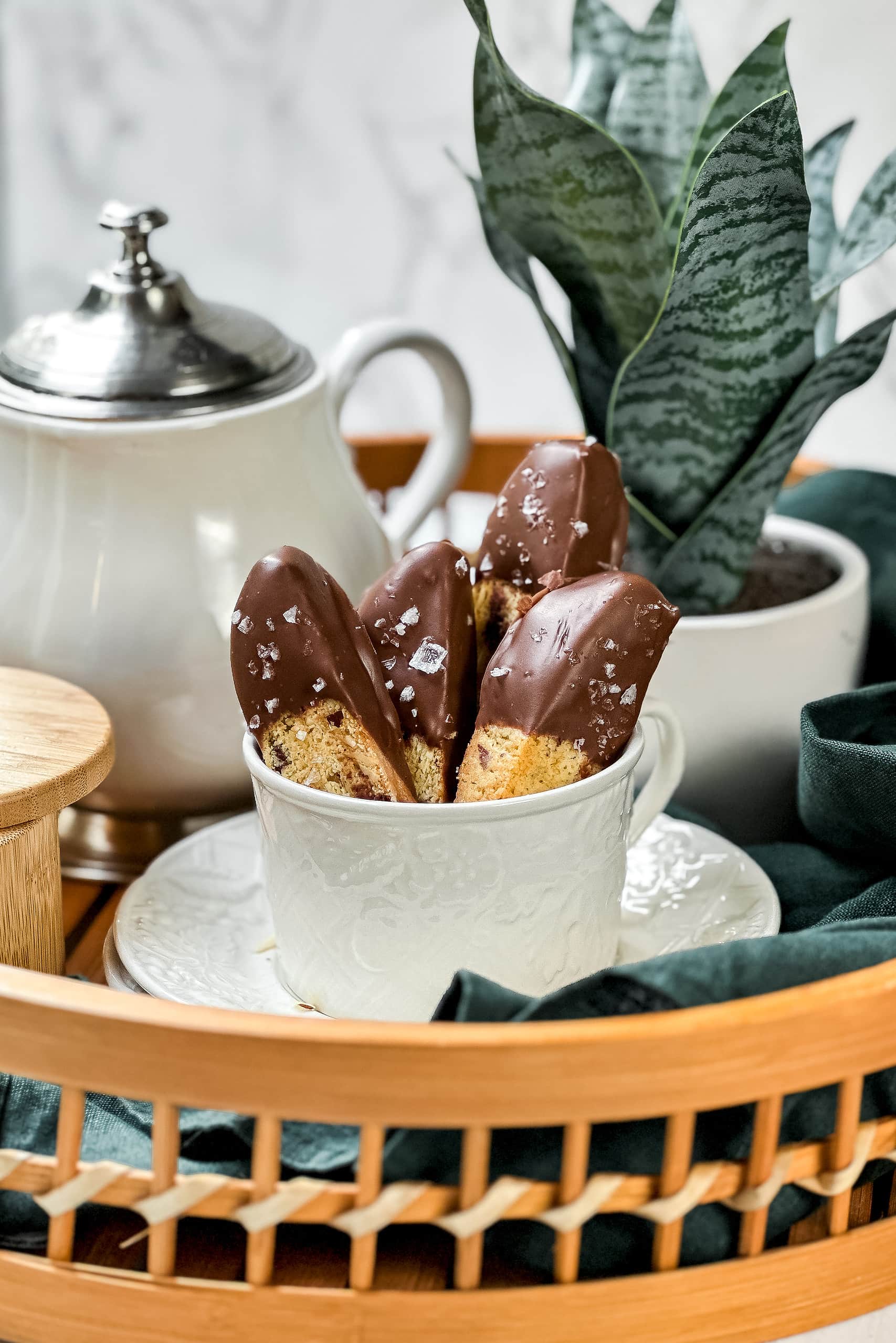 Closeup side view of Chocolate Almond Biscotti in a coffee cup with Italian tea.