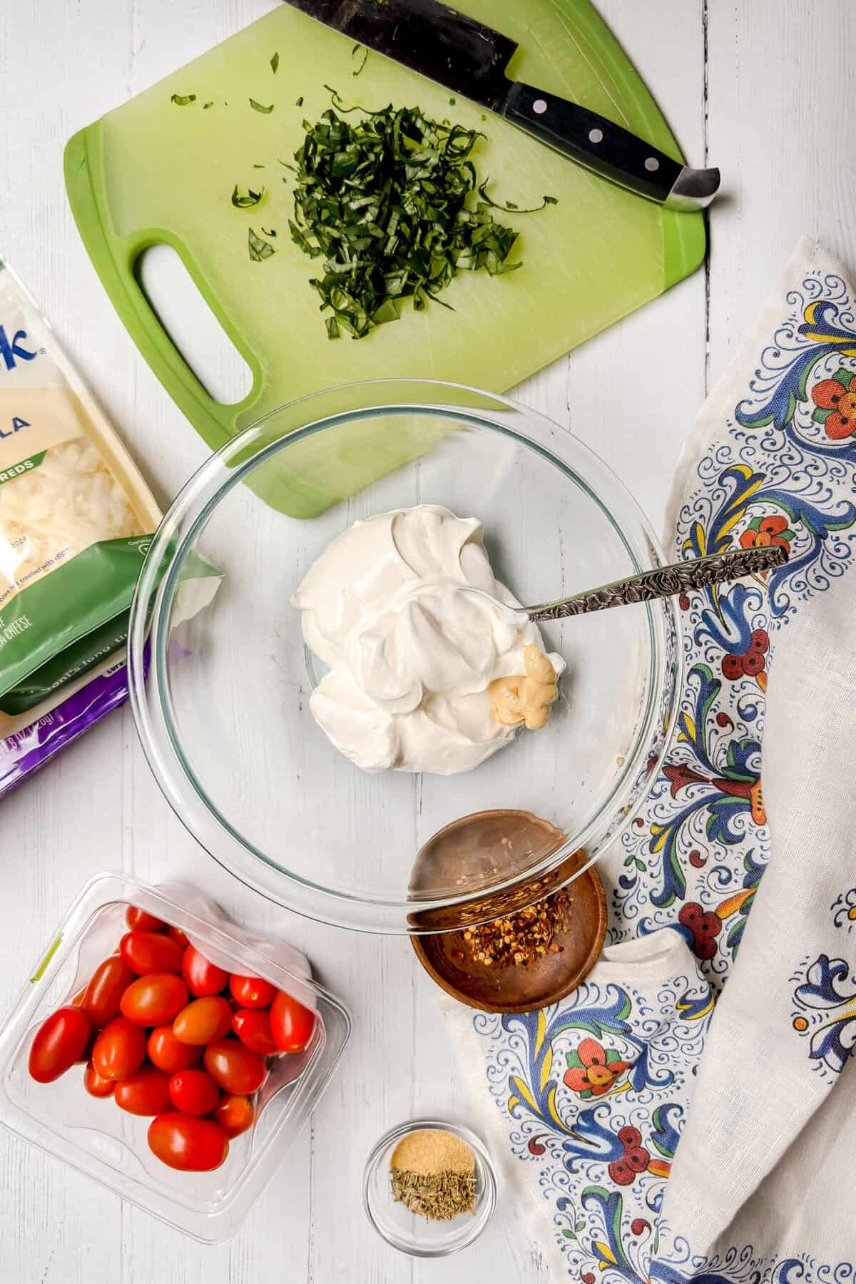 Top view of Caprese Dip ingredients on a white background.