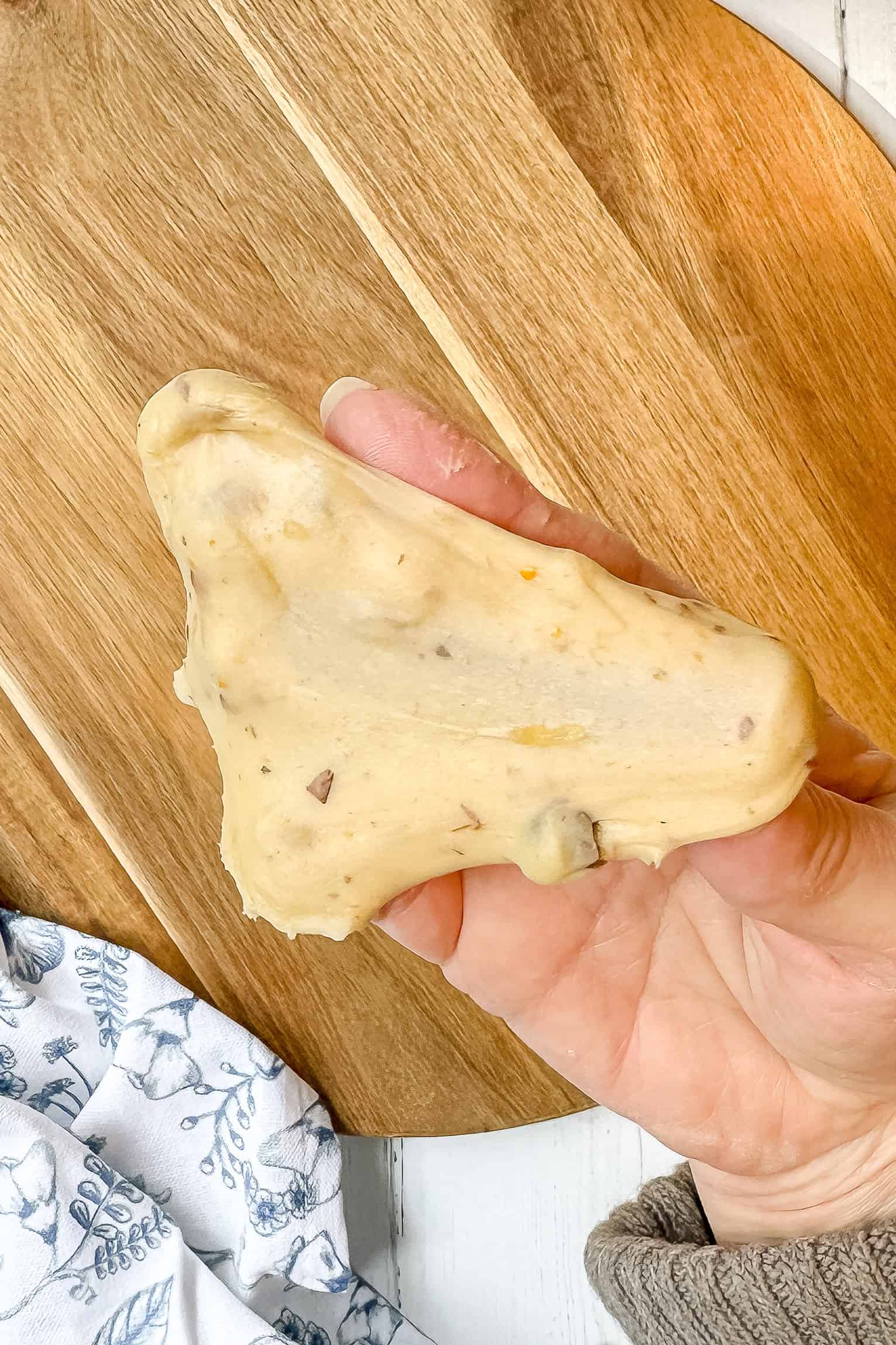 Stretching Osterbrot dough to check gluten development during kneading.