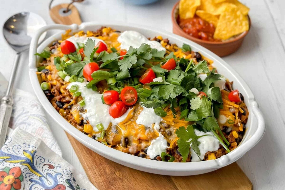 Horizontal side view of easy taco casserole in a white oval casserole dish.