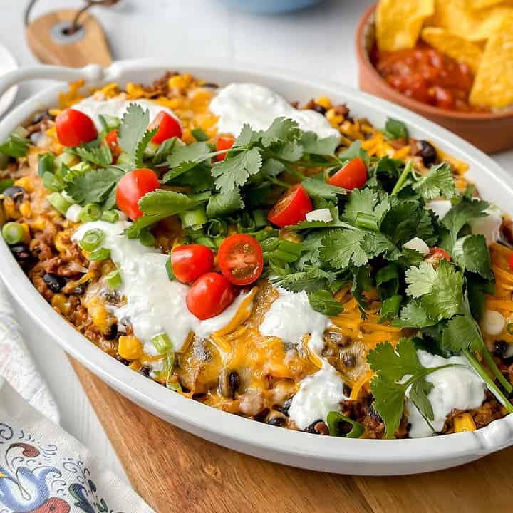 Horizontal side view of easy taco casserole in a white oval casserole dish.