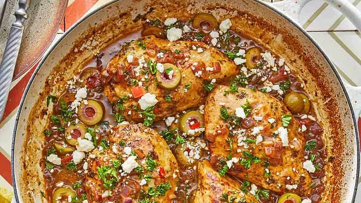 Top view of Mediterranean Chicken in a white skillet for Spring Mediterranean Diet Dinners Meal Plan (April 8)