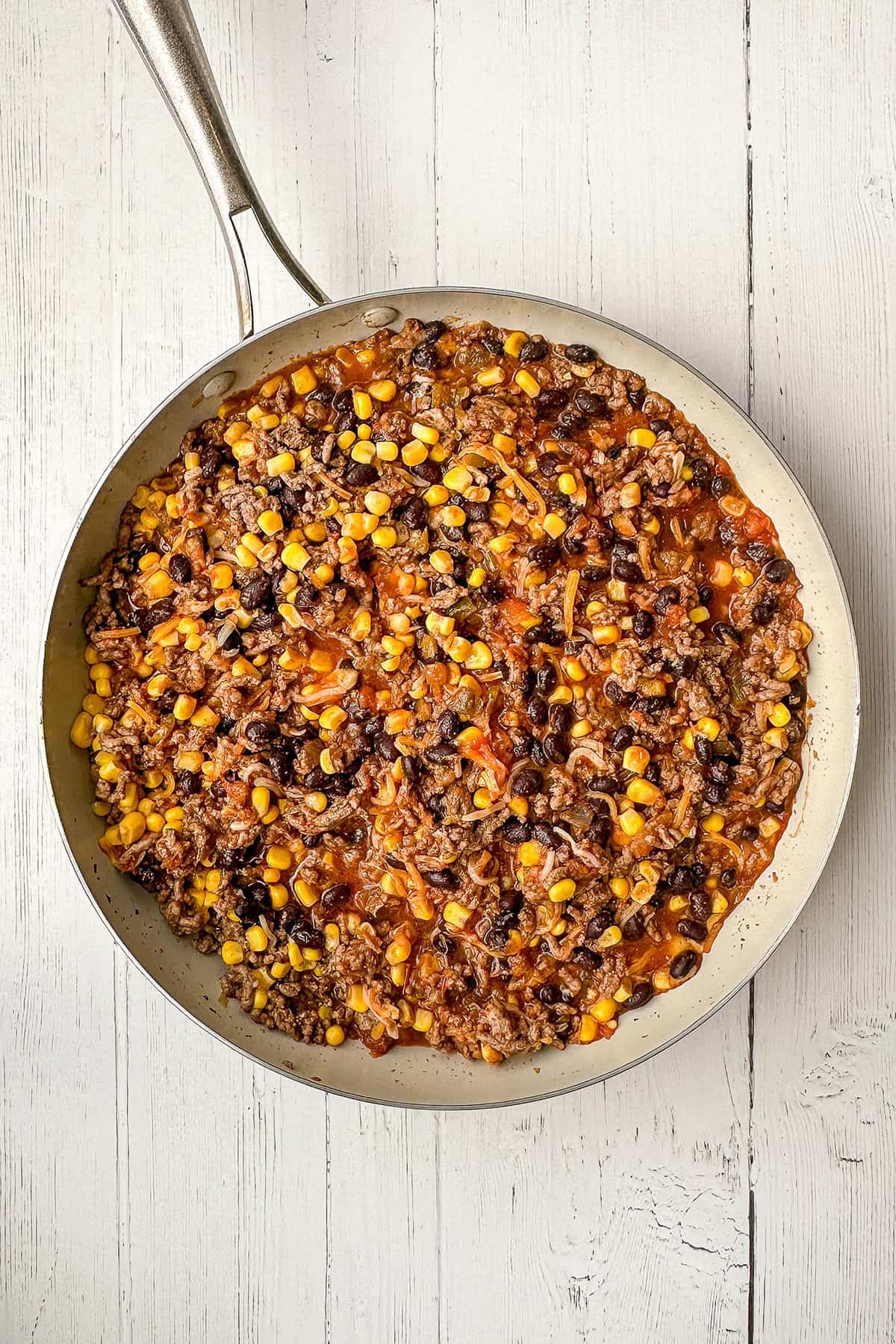 Cooked taco casserole filling in a skillet ready for the casserole.